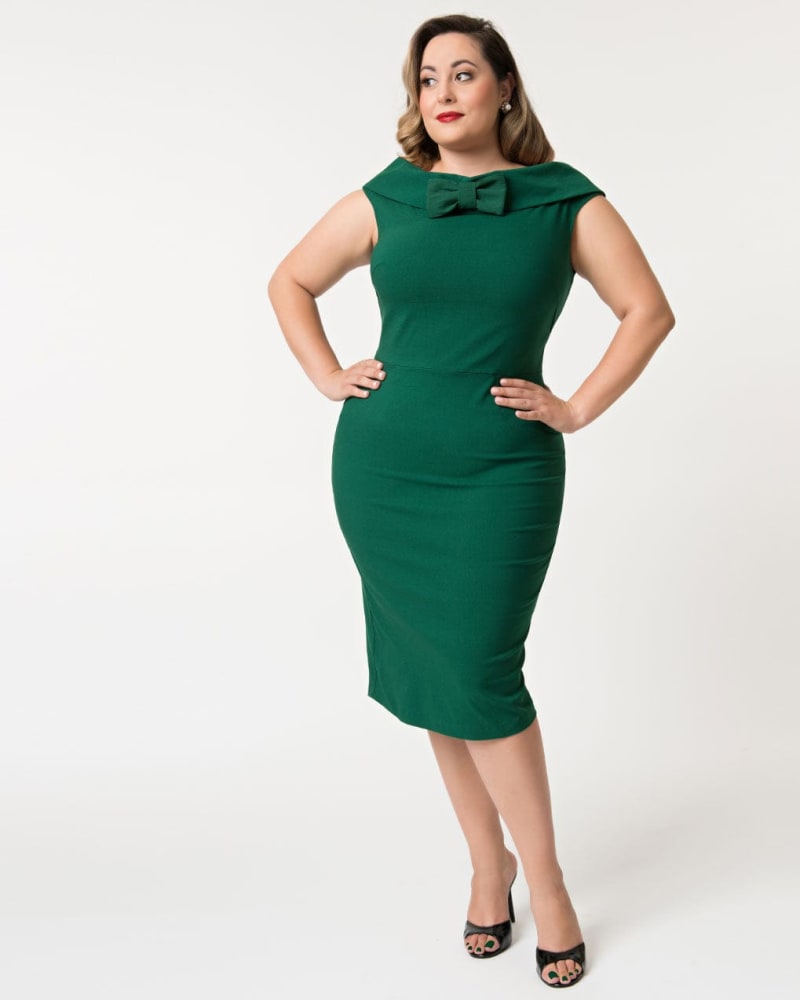Front of a model wearing a size 3X Barbie™ x Unique Vintage 1960s Style Green Sheath Dress in Green by Unique Vintage. | dia_product_style_image_id:318329